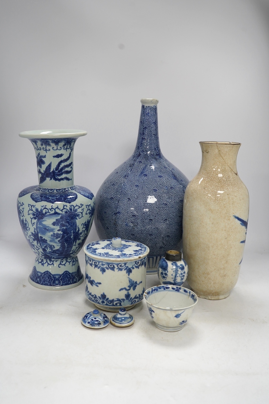 Four Chinese blue and white vases, a jar and cover and a tea bowl, Kangxi to 20th century, tallest vase 38cm high. Condition - poor